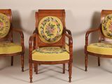 three chairs with yellow cushions and a floral design on them