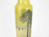 a yellow vase with a painting of a tree on it