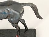 a statue of a horse with a tag on it ' s neck