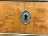 a close up of a wooden dresser with a keyhole