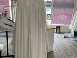 wedding dress hanging on a rack in a bridal shop