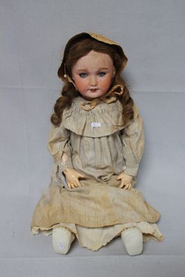 a doll that is sitting on the floor with a hat on