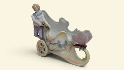 a figurine of a man riding in a carriage