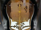a clock inside of a black box with a gold clock face
