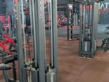 a gym with a lot of machines in the room
