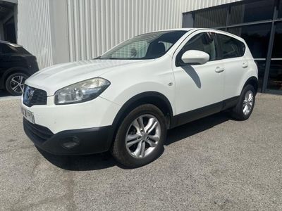 a white car parked in front of a building in a parking lot