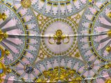 a ceiling decorated with gold and blue designs on it