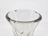 a glass vase that is sitting on a white surface