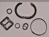 une photo représentant un ensemble d'articles comprenant une ceinture, un bracelet et une bague