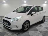 the white ford fiesta is parked in a room with a checkered floor