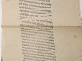 an old piece of paper sitting on top of a white table