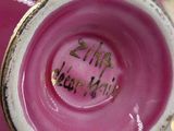 a close up of a pink vase with writing on it