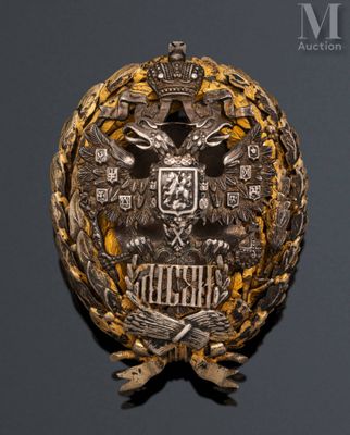a close up of a badge on a black surface with a gray background