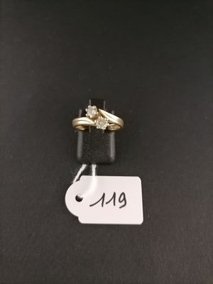 a close up of a pair of wedding rings on a black surface
