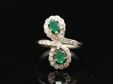 an emerald and diamond bypass ring