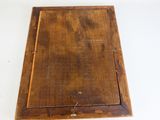 an old wooden box with a hole in it on a white surface