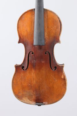 an old violin with a bow hanging from it ' s back