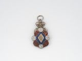 an image of a silver pendant with a blue and red design