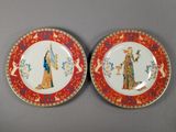 two plates with a painting of a woman and a man on them