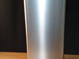 a silver trash can sitting on a wooden table
