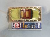 a small toy car in a plastic box on a table