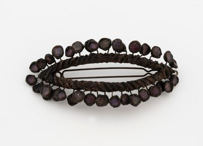 a close up of a hair pin with beads on it