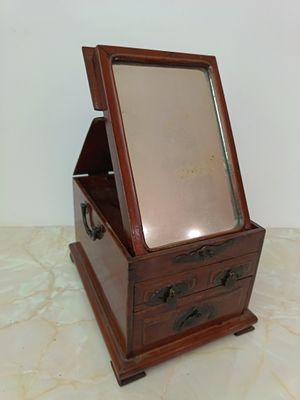 a small wooden box with a mirror in it