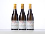 three bottles of wine sitting on top of a table