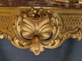 a gold table with a clock on top of it