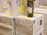 boxes of wine are stacked on top of each other on a pallet