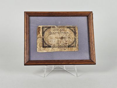 une photo encadrée représentant une feuille de papier sur laquelle figure la photo d'un homme