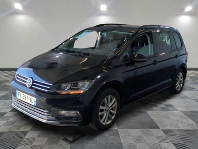 the black volkswagen touran is parked in a room with a checkered floor
