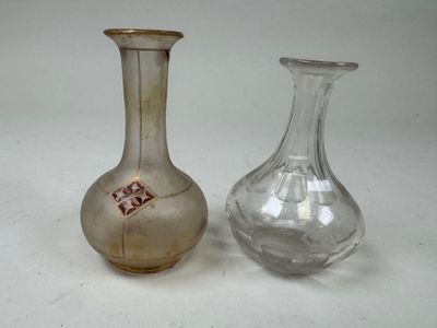 two glass vases sitting next to each other on a table