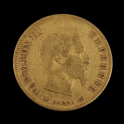 a close up of a gold coin on a black background