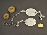 two silver and gold bracelets and a coin on a table