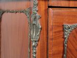a wooden cabinet with a metal handle on top of it