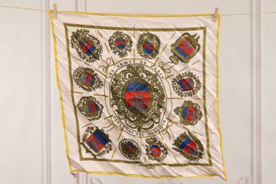a picture of a white and gold scarf hanging on a clothes line