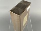 a cardboard box that is sitting on a clear stand