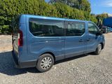 a blue van that is parked in a parking lot