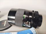 a camera lens sitting on a table next to a cell phone