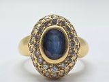 an image of a gold ring with a sapphire and diamonds