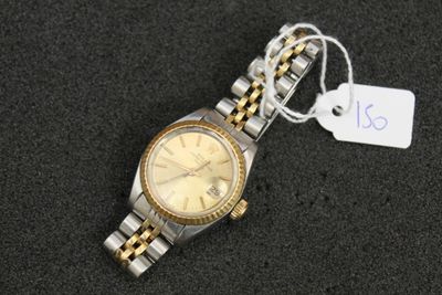 an image of a watch with a tag attached to it ' s wrist