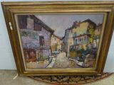 une peinture à l'huile représentant une scène de rue, dans un cadre en bois