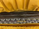 the inside of a yellow purse with a black and white pattern