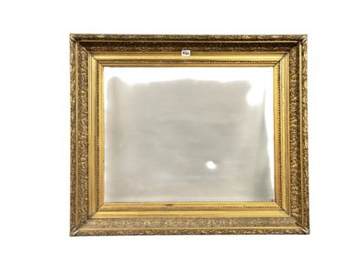 a gold framed mirror on a white wall