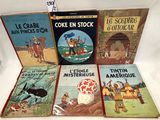 six children ' s books are lined up on a white surface