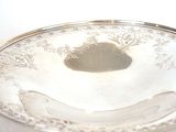 a silver plate with a banana on it on a table