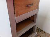 a small cabinet with a drawer on top of it