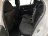 the back seats of a white car with a black seat belt