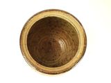 a brown bowl sitting on top of a white table